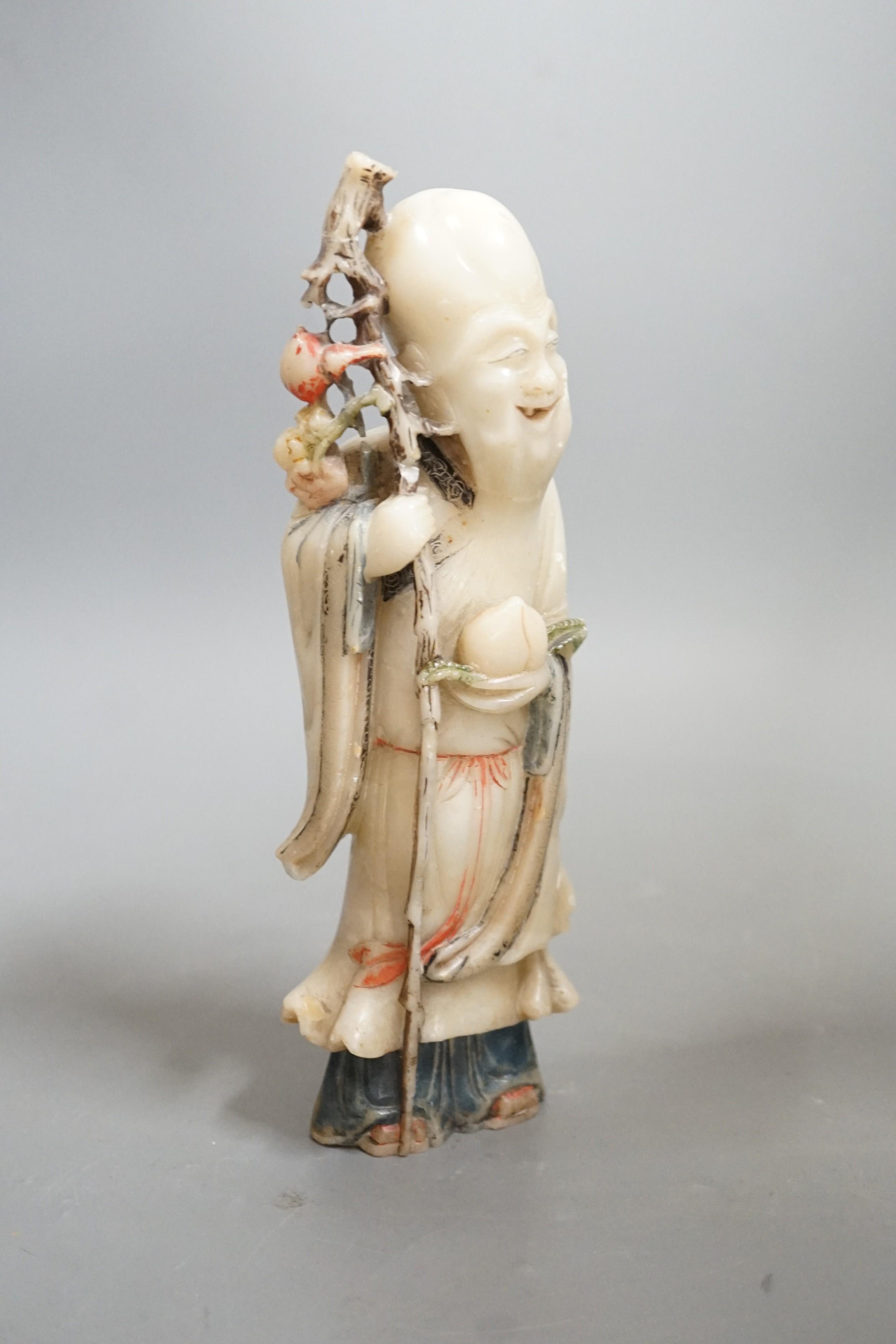 An 18th century Chinese carved soapstone figure of Shao Lou on carved hardwood stand. 24cm high (a.f.)